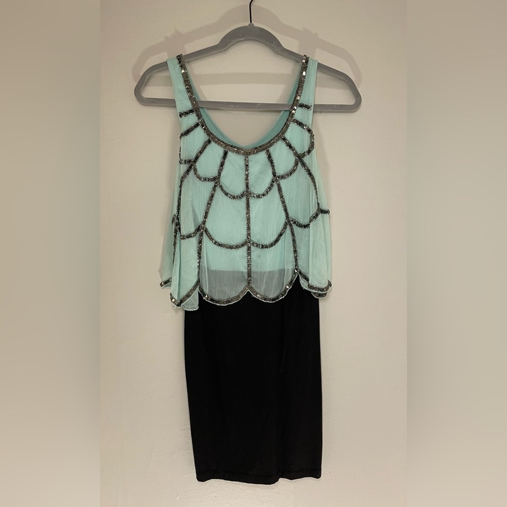 Mint overlay top beading. Scalloped edges. Lined with black stretch knit skirt